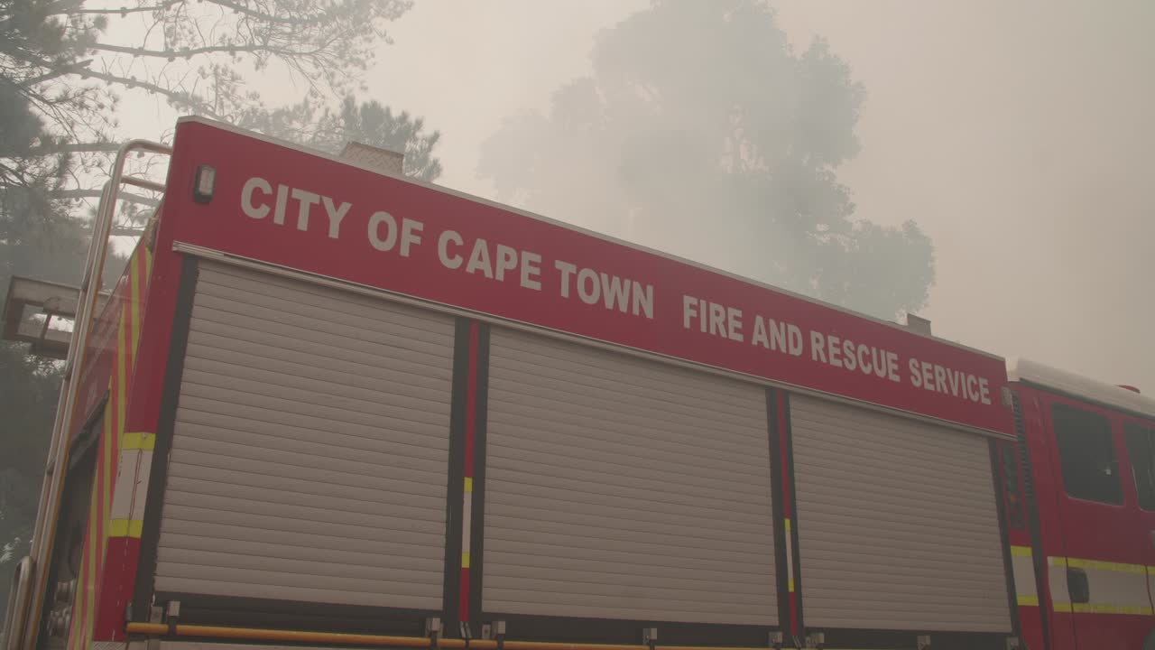 A firetruck from the City of Cape Town parked next to the scene of a wild fire in the forests near Cape Town