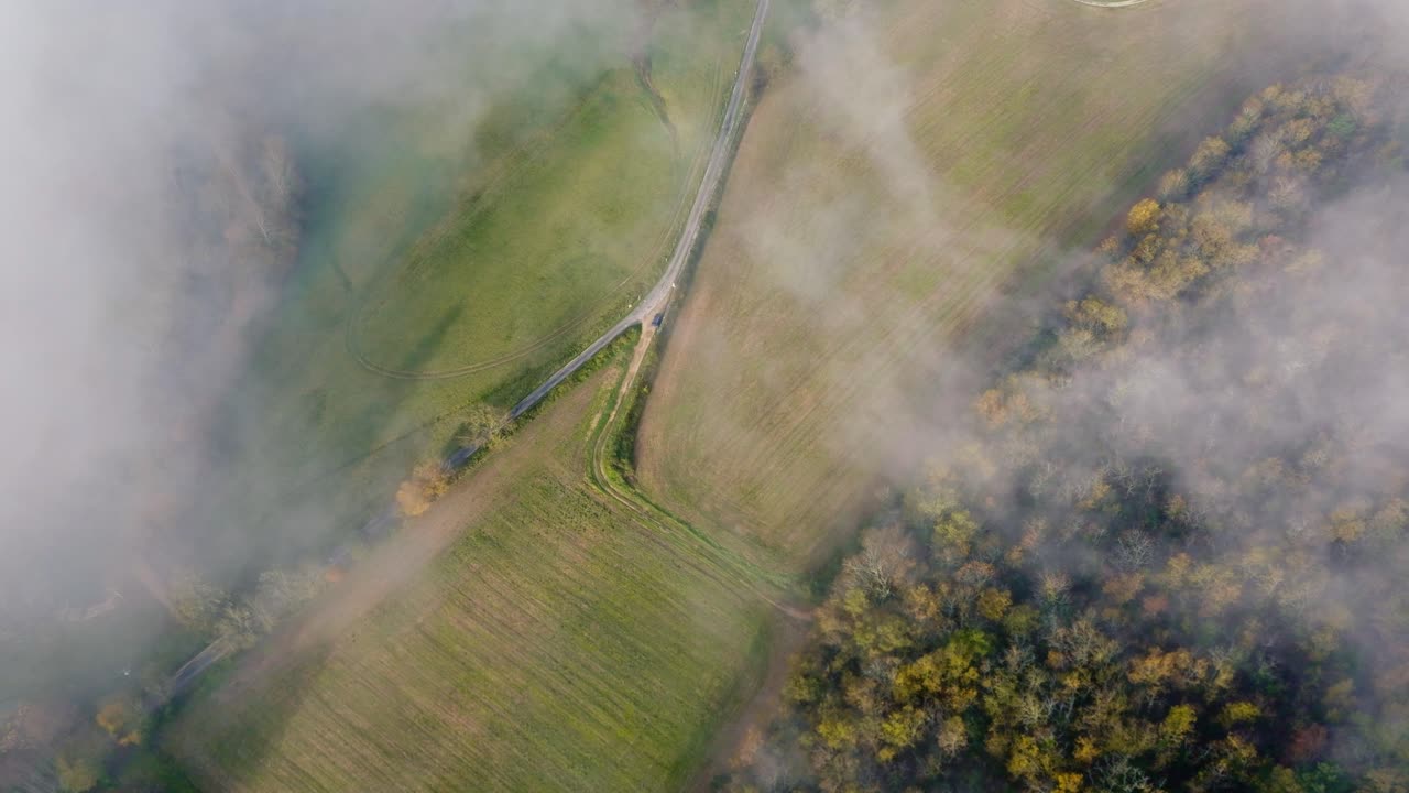 Gentle descent to the ground and passing clouds, wide-angle sunrise drone shot, Dordogne, France