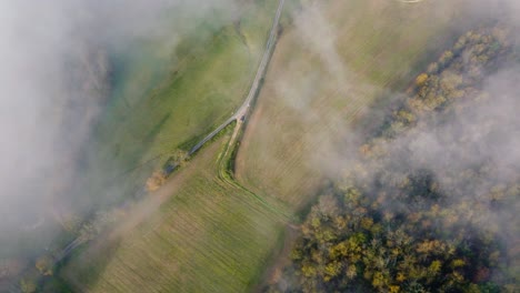 Gentle descent to the ground and passing clouds, wide-angle sunrise drone shot, Dordogne, France