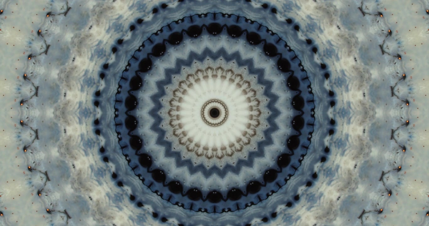 Blue ink creating kaleidoscope