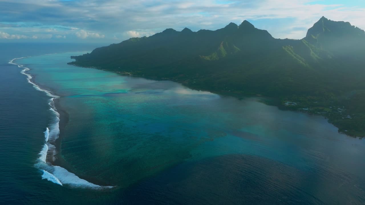 Cooks Opunohu Bay Moorea island French Polynesia aerial drone morning sunrise boats Passe clear skies lagoon coral reef waves Mount Mauaroa Tohivea Rotui Haapiti Pacific Ocean forward pan up motion