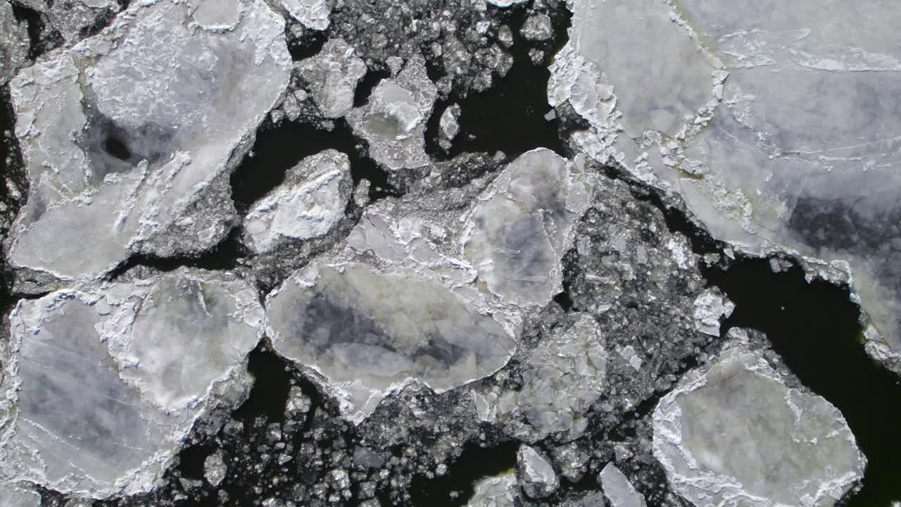 Beautiful ice formations on river from above, long calm overhead aerial clip, 4K