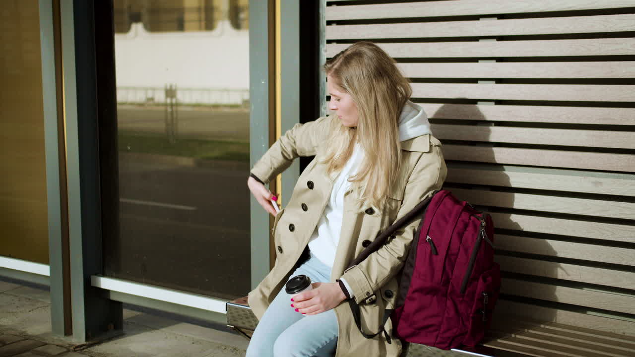 Young woman sitting at bus stop