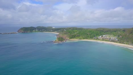 Spectacular-aerial-morning-flight-over-wild-blue-ocean-towards-bay,-Australia