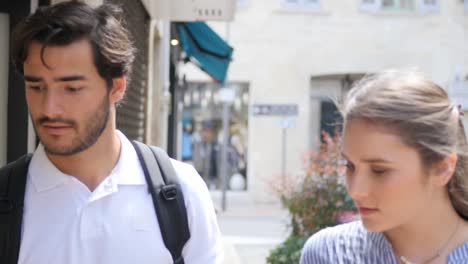 cheerful young couple on cultural weekend city trip discovering together historical european city in summer