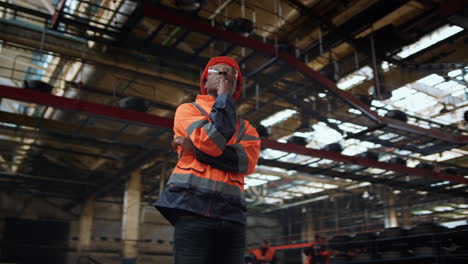 industrial supervisor thinking wearing safety uniform at modern warehouse.