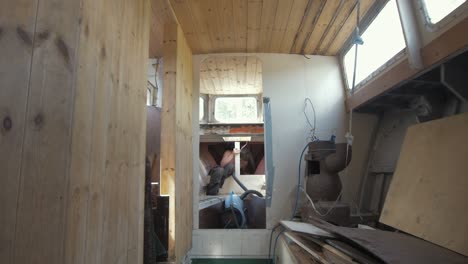 young man working in vberth of wooden liveaboard boat