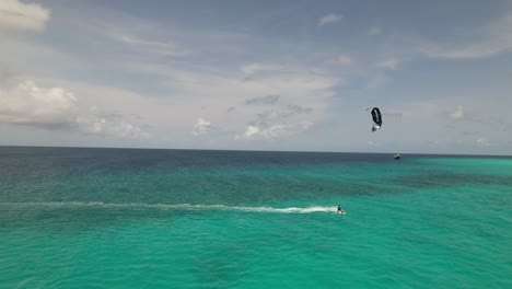 stunning aerial footage of kite surfers sailing near a small island in the caribbean sea