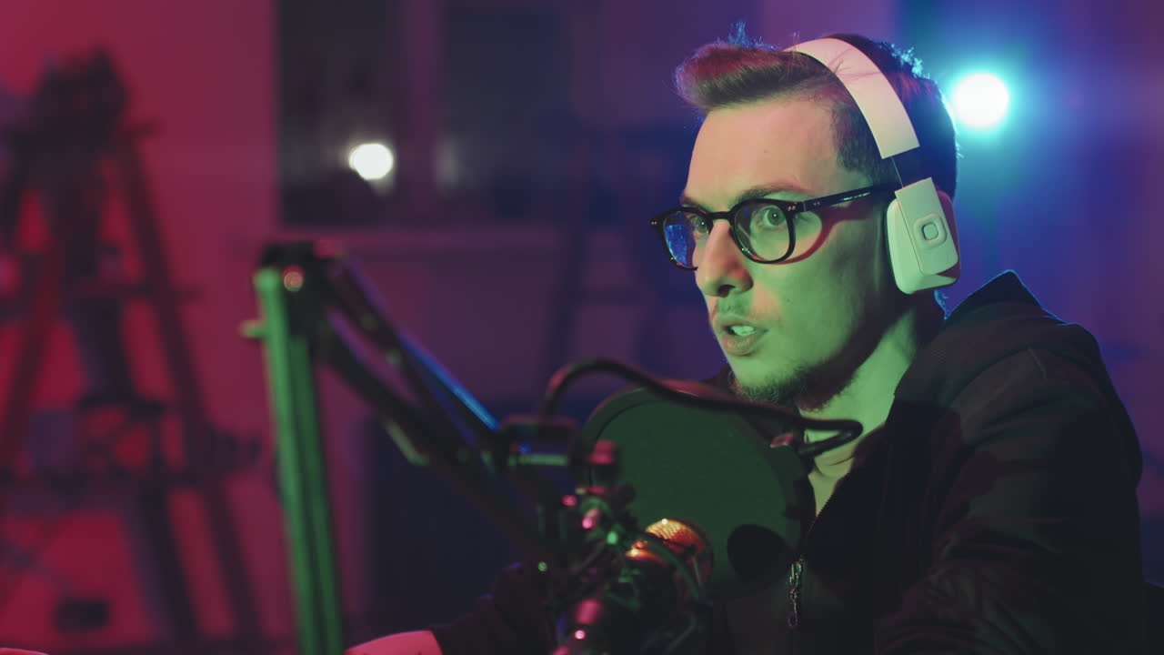 Man with Glasses Talking on Podcast