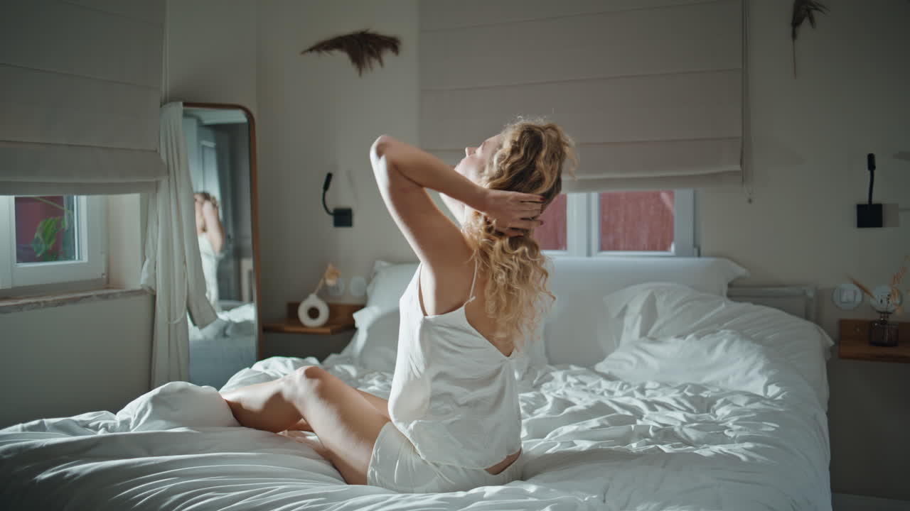 Morning lady stretching body in cozy sunlit apartment. Wellbeing morning routine