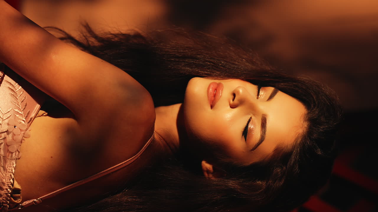 Young beautiful woman enjoying the glow of natural light at sunset with head tilted back and eyes closed