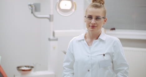 Young-Positive-Female-Dentist-Smiling-At-Dental-Clinic-1