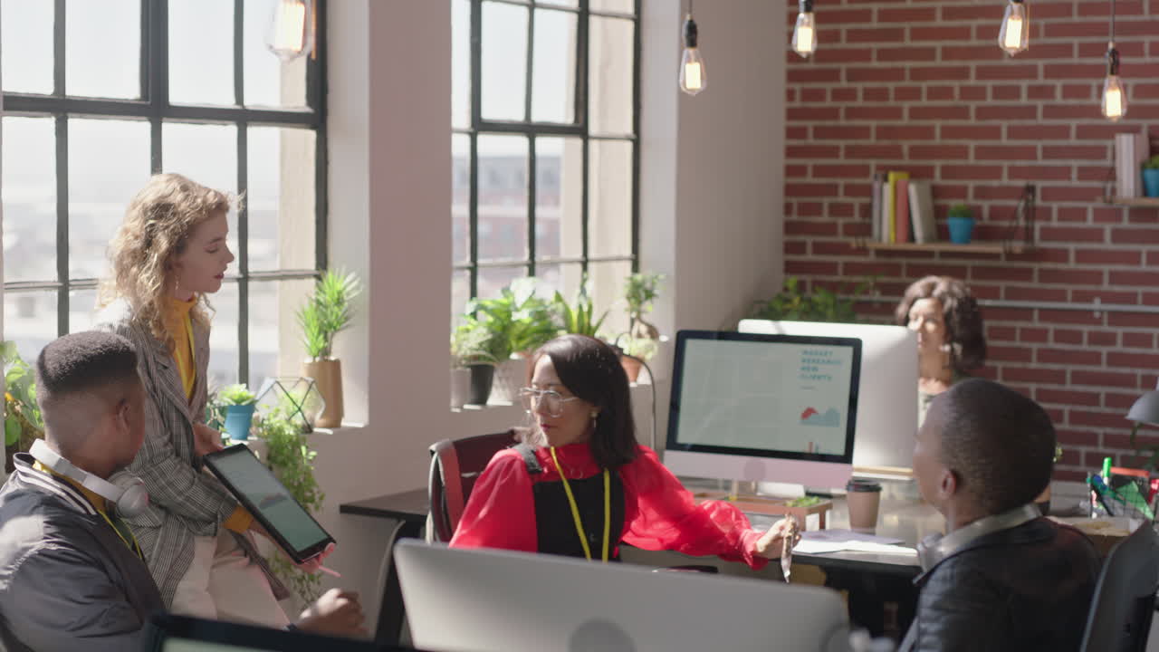 young business people meeting beautiful redhead team leader woman using tablet computer showing creative project ideas on screen sharing strategy colleagues collaborating in office briefing