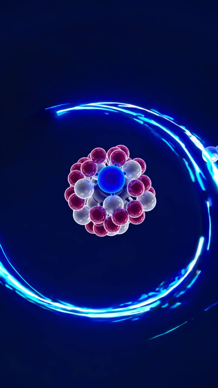A top-down video view of a glowing atomic model with vibrant blue and red particles orbiting, set