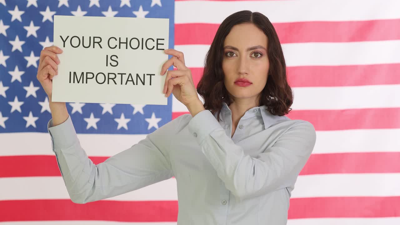 Woman holding "Your Choice Is Important" sign with American flag in background