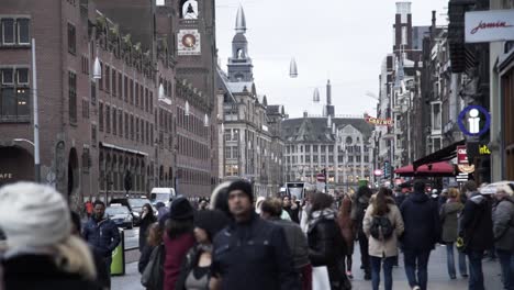 people walk on the damrak in amsterdam,  netherlands streets full of people walking crowded day every day lifestyle