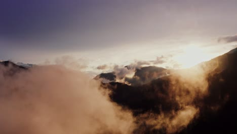 sunrise or sunset over misty mountains