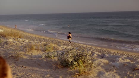 woman running on a beach at sunset