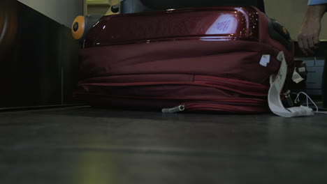 suitcase on luggage conveyor belt at airport