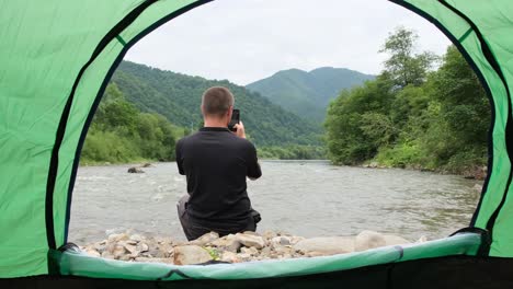 a beautiful view from a tent on the bank of a raging mountain river a beautiful view from a tent on the bank of a raging mountain river the beauty of the ukrainian carpathians