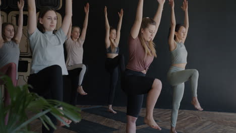 women in yoga class practicing balancing poses