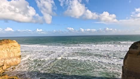 ocean waves crashing against iconic limestone cliffs