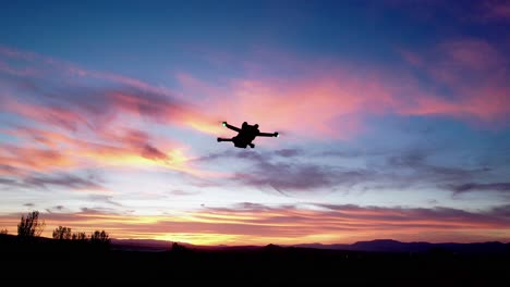 drone in night flight with position lights flashing. drone flying with colorful sky at sunset. granada. andalusia. spain.