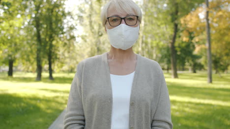 senior woman wearing mask in park