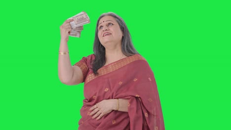 Cheerful-Indian-old-woman-using-money-as-fan-Green-screen