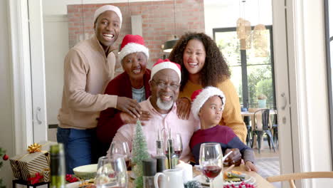 portrait of happy african american multi generation family at christmas dinner table