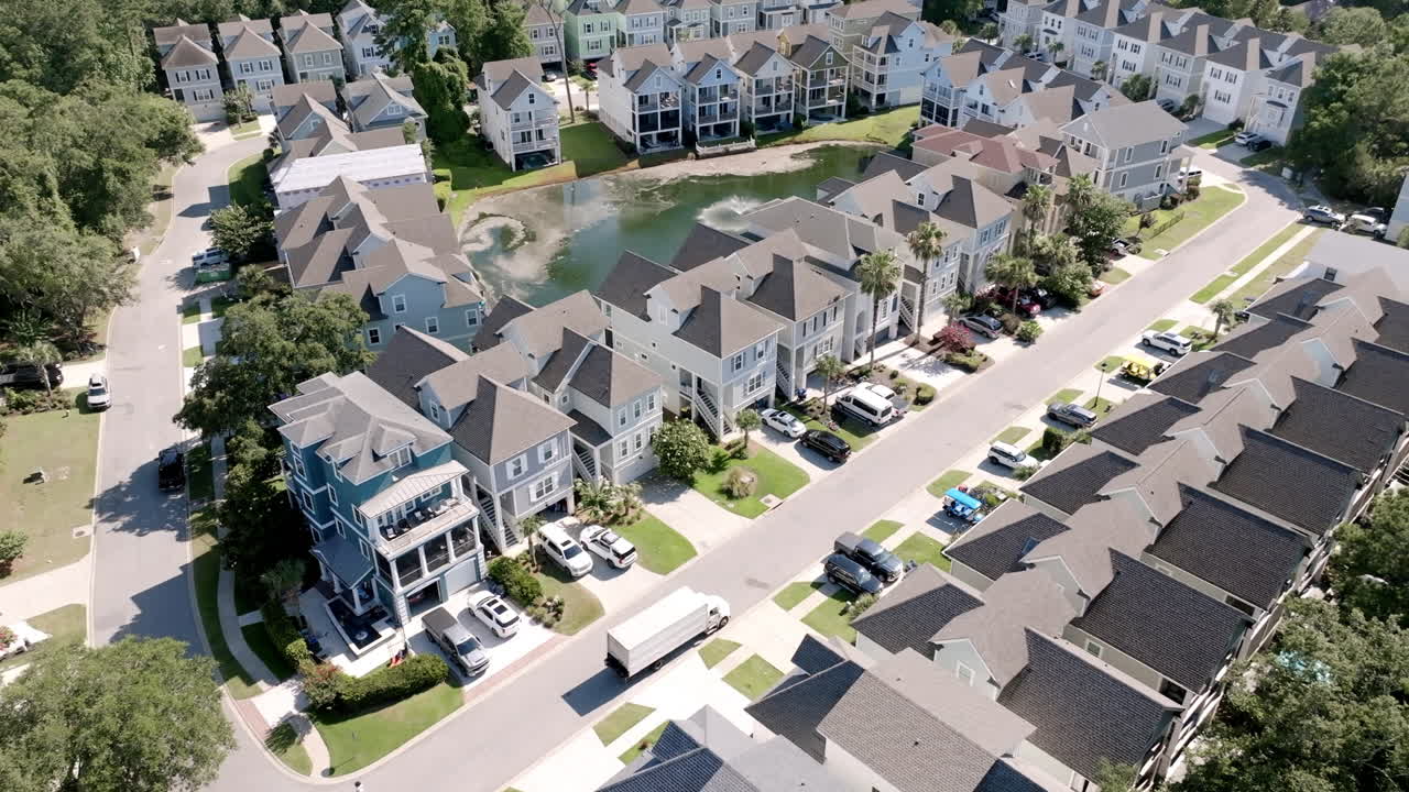 Aerial view of a planned Hilton Head Island neighborhood, showing rows of pastel coastal homes and tree-lined streets