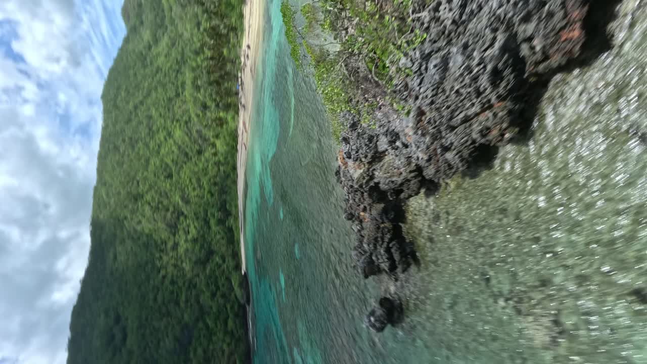 Vertical video, beautiful fpv racing flight over turquoise Caribbean ocean water
