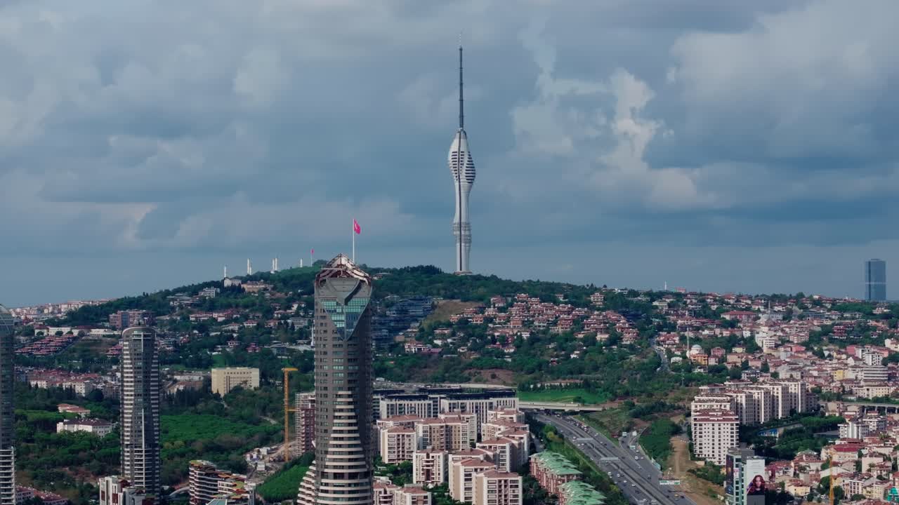 Beautiful drone footage of Çamlıca Tower, the tallest structure in Istanbul, Turkey. The video highlights the unique modern design of the tower surrounded by residential neighborhoods, green hills