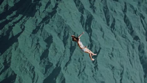 woman flying above mountains