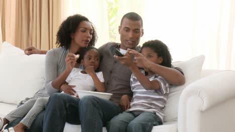 AfroAmerican-parents-and-children-watching-television-