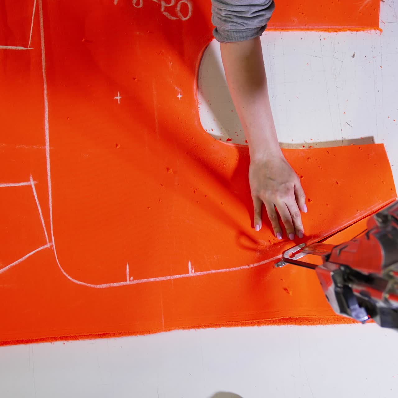 Close up of sewing process. Dressmaker woman making clothes on sewing machine in factory