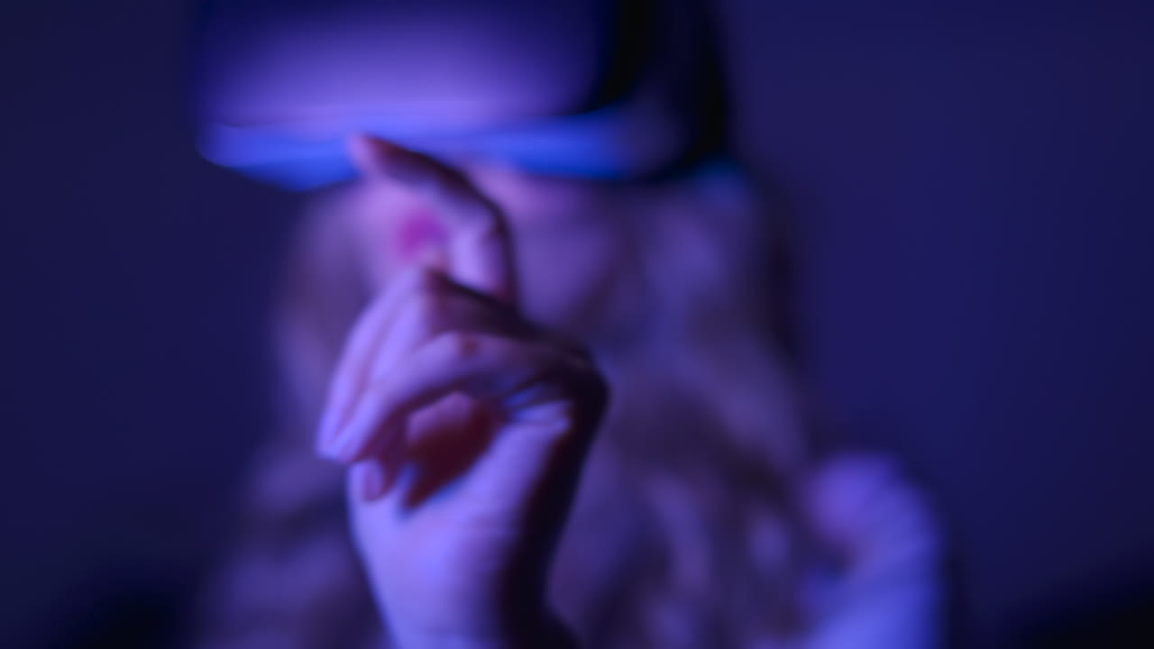 Woman using Virtual Reality headset at night