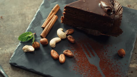 Chef-hands-decorating-chocolate-cake-with-fresh-mint-leaves-in-slow-motion.