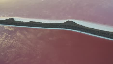 aerial view of sky mirror reflection on pink lakes water surface great salt lake utah usa, drone shot