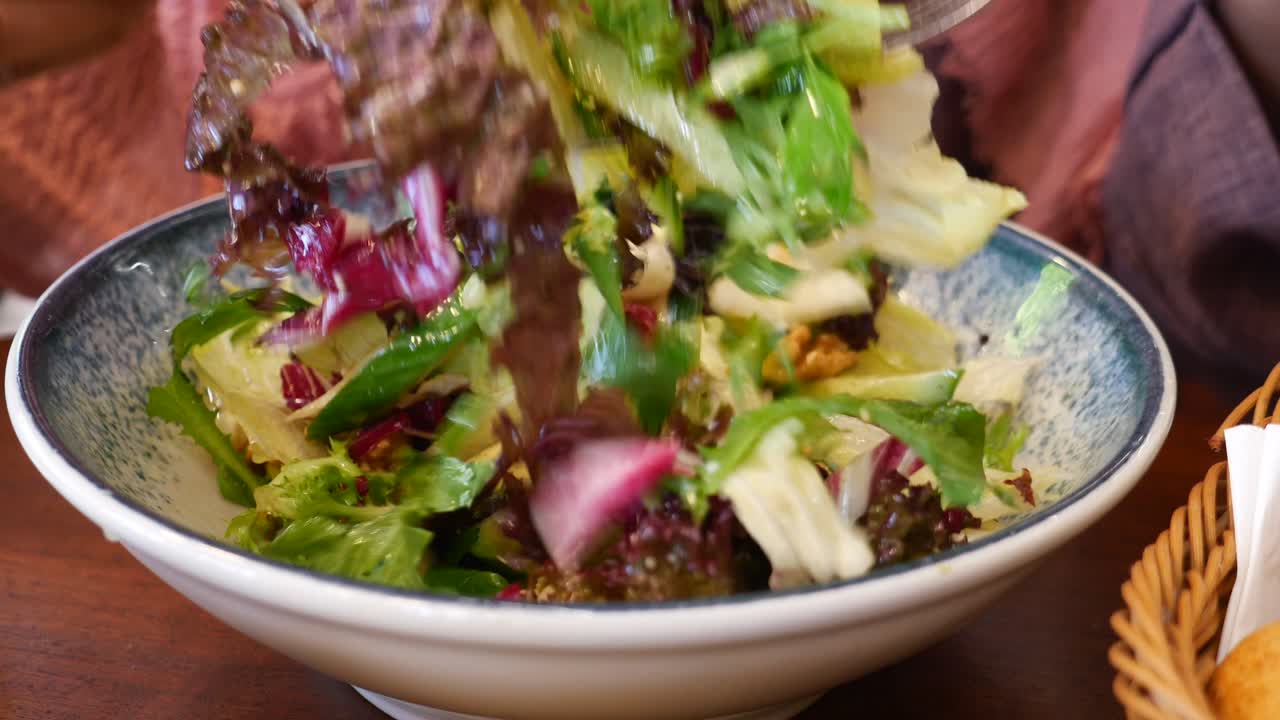 레스토랑에서 신선한 녹색 러드를 먹는 여자