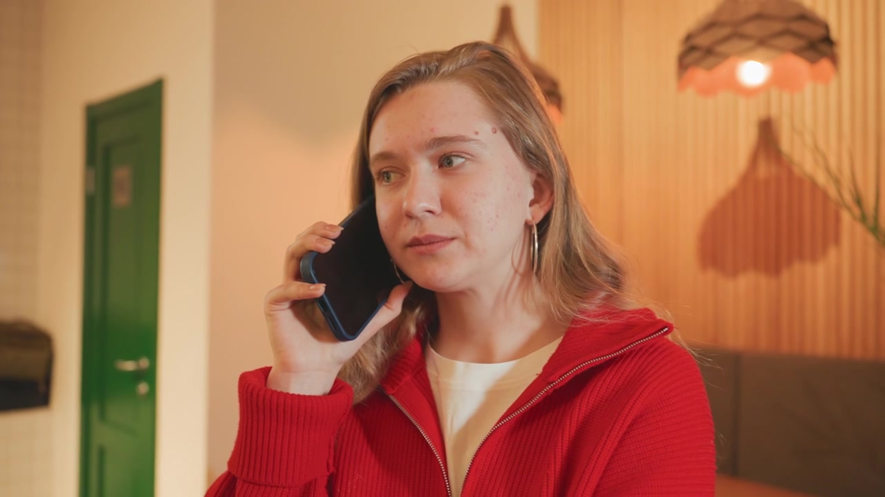 Young Woman Listening on Smartphone During a Call