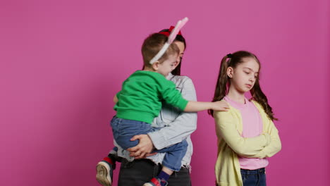 little children having a fight against pink background