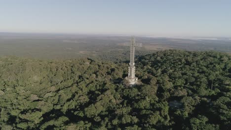 drone long shot flying towards the cruz de santa ana surrounded by deep natural forest in misiones, argentina