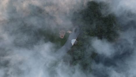 a small hole in a fog cloud reveals the ground below it