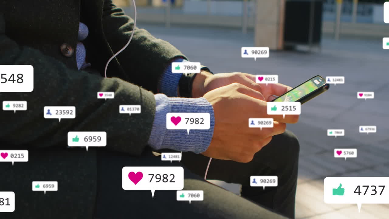 Animation of social media icons against mid section of businessman using smartphone on the street