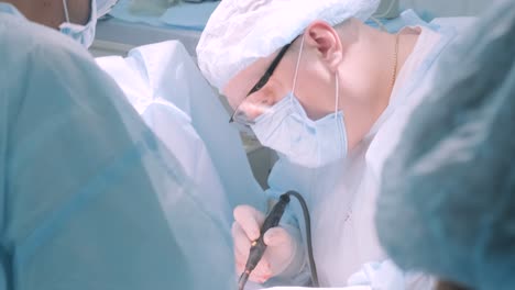 a surgeon in a sterile operating room performing a surgical procedure with focus and precision. represents healthcare, surgery, medical expertise, and patient care