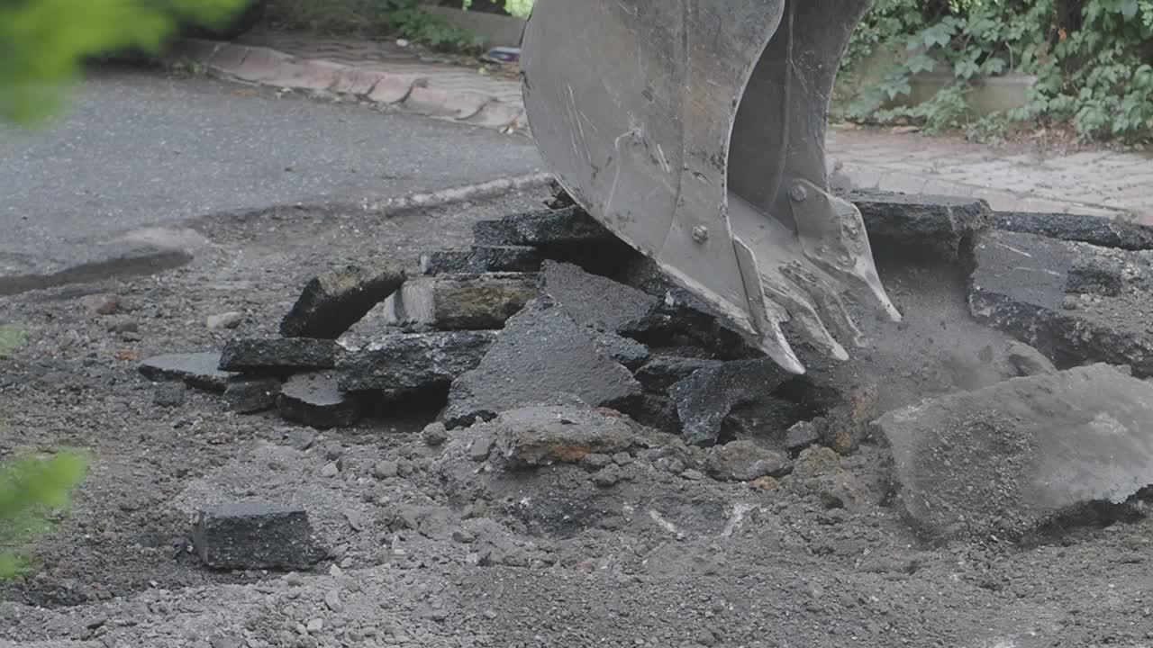 Excavator Removing Asphalt