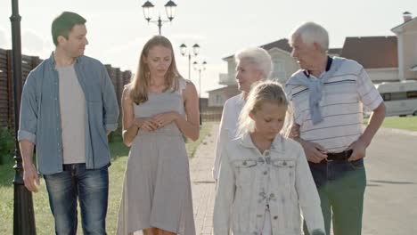 family taking stroll in countryside