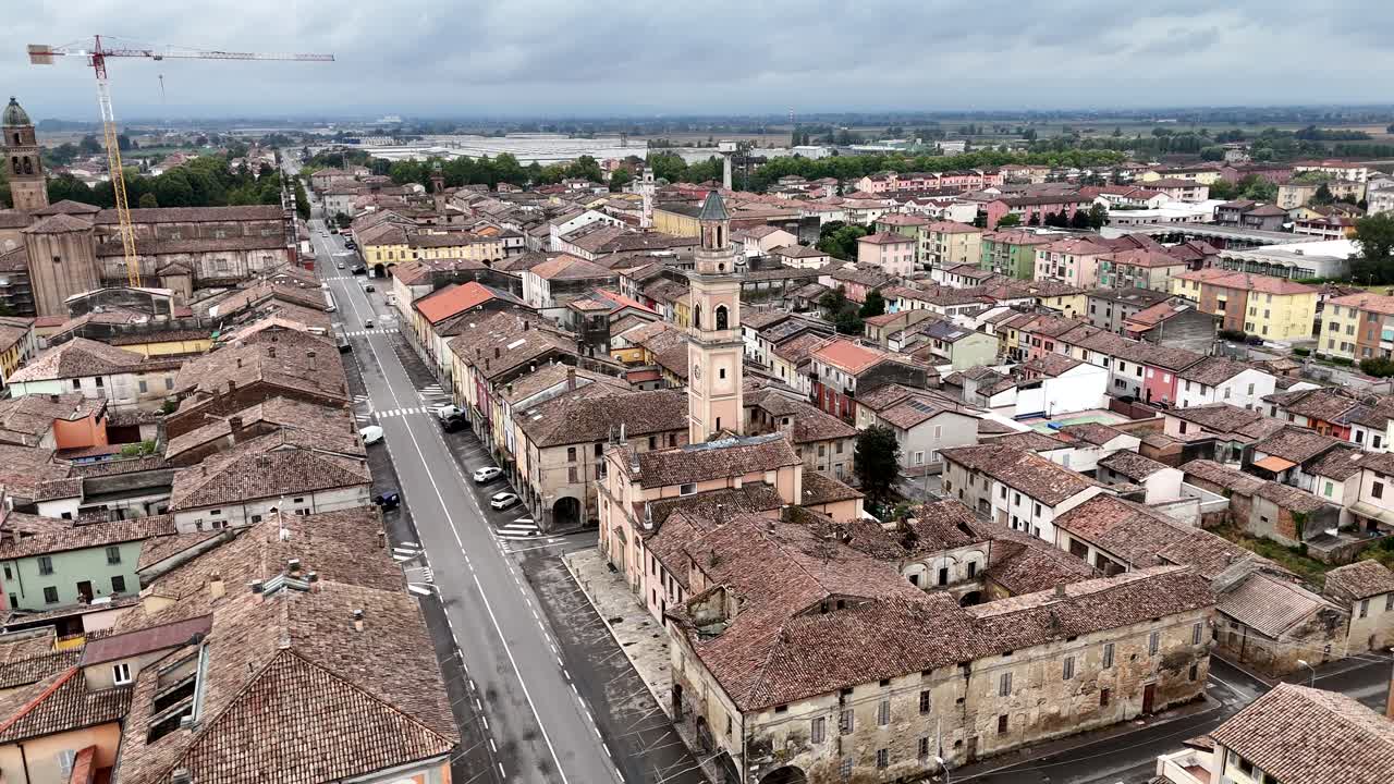 Drone aerials capture historic Cortemaggiore PC town Italian countryside rooftops churches bell towers and streets revealing charming European urban landscape scenery