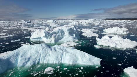 spectacular aerial view of massive melting icebergs, during summer in icefjord, greenland